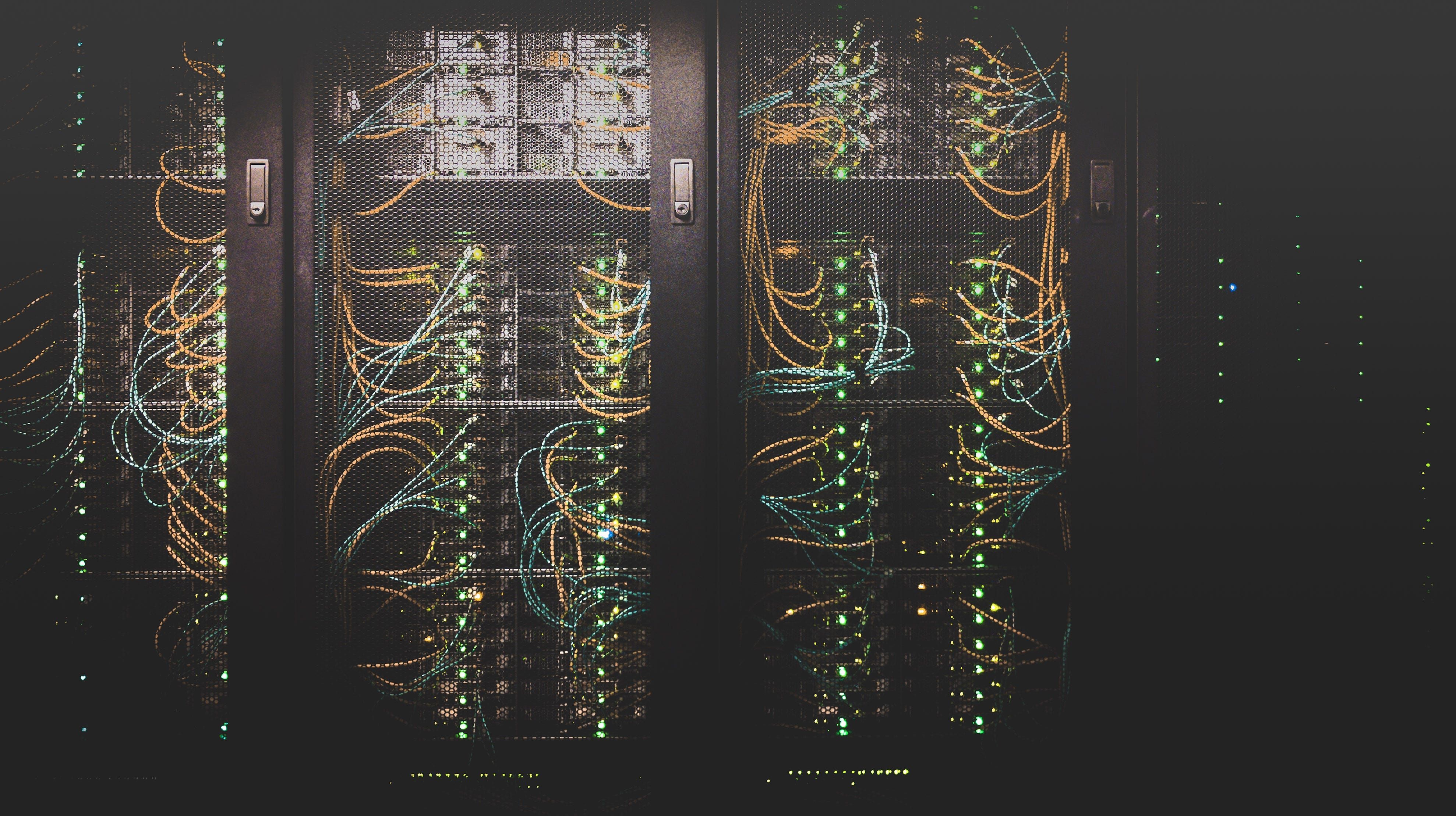 Server cabinets in a dark room with structured cabling